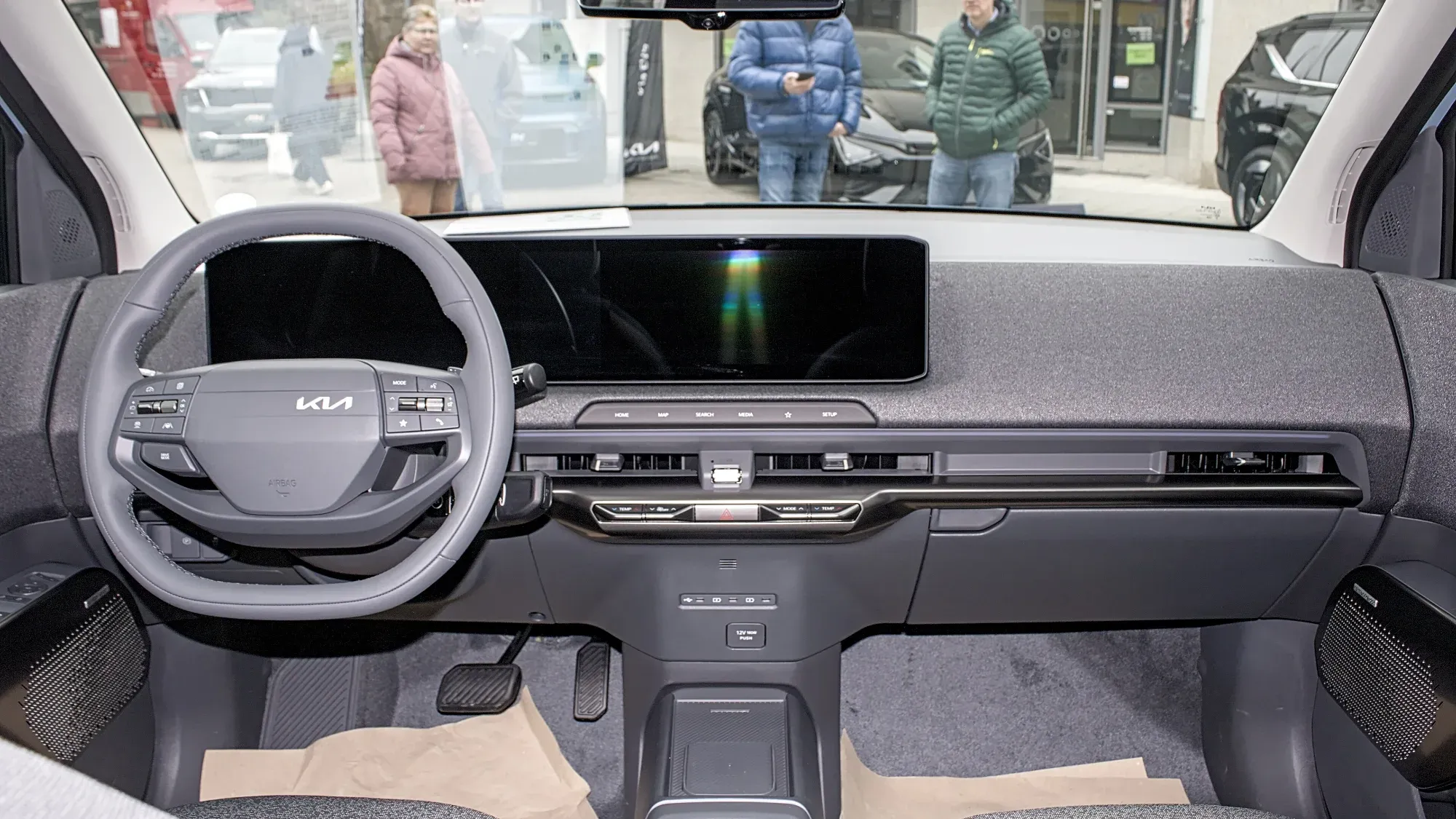 Tablero del Kia EV2, con volante de dos radios y pantallas unidas en un solo panel